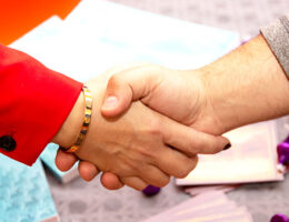 Two women shaking hands
