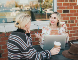 Michelle Perchuk and client chatting over coffee outside a cafe